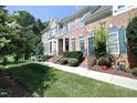 Inviting brick townhome with a landscaped front yard, a balcony, and a peaceful setting at 2318 Carriage Oaks Dr, Raleigh, NC 27614