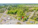 Overhead view of a residential area showcasing the home's location, mature trees and community features at 2500 Courtland Dr, Sanford, NC 27330