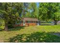 Charming brick home with well-maintained lawn, complemented by mature trees and a screened in patio at 2500 Courtland Dr, Sanford, NC 27330