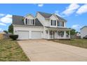 Charming two-story home featuring a welcoming front porch and attached two-car garage at 281 Highland Forest Dr, Sanford, NC 27332
