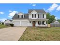 Charming two-story home featuring a welcoming front porch and attached two-car garage at 281 Highland Forest Dr, Sanford, NC 27332