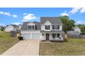 Charming two-story home featuring a welcoming front porch and attached two-car garage at 281 Highland Forest Dr, Sanford, NC 27332