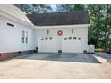 Spacious two-car garage with ample parking and additional side yard space at 304 Parkridge Dr, Clayton, NC 27527