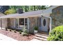 Charming stone home with a well-maintained front yard and inviting entrance at 305 Clarendon Cres, Raleigh, NC 27610
