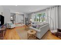 Bright living room with hardwood floors, comfortable seating, and large windows for natural light at 305 Clarendon Cres, Raleigh, NC 27610