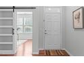 Bright entryway with a sliding barn door, and hardwood floors at 3148 Rapid Falls Rd, Cary, NC 27519