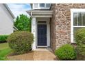 Close-up of the home's entrance, with a stone facade and manicured bushes at 3148 Rapid Falls Rd, Cary, NC 27519