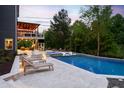 Luxurious backyard with pool, hot tub, sun loungers, and covered patio; perfect for entertaining at 3215 Bellamy Ridge Dr, Apex, NC 27523