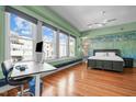 Bright bedroom with hardwood floors, large windows, and a modern ceiling fan at 323 W Main St # C, Durham, NC 27701