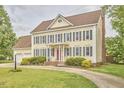 Traditional two-story home with yellow siding, grey shutters, a red door, and landscaped front yard at 3809 Victorian Grace Ln, Apex, NC 27539