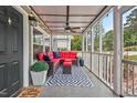 Inviting screened porch with stylish furnishings and ceiling fan at 3902 Booker Ave, Durham, NC 27713