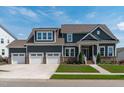 Beautiful two-story home featuring a three car garage and manicured lawn at 400 Chickasaw Plum Dr, Holly Springs, NC 27540