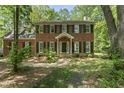 Traditional brick home with black shutters and green lawn shaded by mature trees at 4041 Brook Cross Dr, Apex, NC 27539