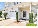 A bright, inviting entrance with a glass front door and neatly trimmed bushes at 412 Stone Flower Ln, Raleigh, NC 27603