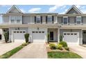 Charming townhome featuring a one-car garage, inviting front entrance, and meticulously landscaped yard at 412 Stone Flower Ln, Raleigh, NC 27603