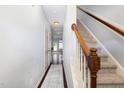 A long hallway with hardwood floors leads to a carpeted staircase at 412 Stone Flower Ln, Raleigh, NC 27603