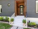 Close-up of the home's entryway featuring a welcoming front door and nicely landscaped steps at 4521 Briarglen Ln, Holly Springs, NC 27540
