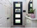 A bright hallway features a stylish front door, ample storage, and modern decor at 4521 Briarglen Ln, Holly Springs, NC 27540