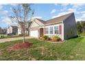 Well-maintained home with manicured lawn, complementing the light-colored siding and accentuating the architectural design at 46 S Great White Way, Clayton, NC 27527
