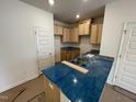 Bright kitchen features light wood cabinets, granite countertops, and stainless steel sink at 503 Eastwood St, Durham, NC 27703