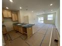 Open-concept kitchen with light wood cabinetry flows into the expansive living area at 503 Eastwood St, Durham, NC 27703