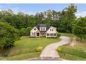 Stunning home with meticulous landscaping, a long driveway, and surrounded by mature trees at 5209 Thistleby Rd, Fuquay Varina, NC 27526