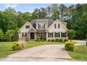 Beautiful home with mature landscaping, stone accents, and a well-maintained driveway at 5209 Thistleby Rd, Fuquay Varina, NC 27526