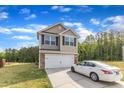 Two-story home with a two-car garage and well-maintained lawn and neutral siding at 536 Gusty Ln, Zebulon, NC 27597