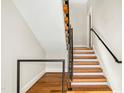Modern staircase with wooden steps, sleek black railings, and contemporary design elements at 607 Smedes Place # B, Raleigh, NC 27605