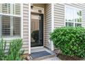 Inviting front entrance features decorative shrubbery and sidelight window at 7229 Terregles Dr, Raleigh, NC 27617