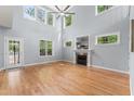 Bright living room featuring tall windows, a fireplace, and hardwood floors at 84 N Hadrian Ct, Clayton, NC 27520