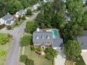 Aerial shot of a home with a swimming pool, well-kept landscaping, and mature trees at 101 Conway Ct, Cary, NC 27513