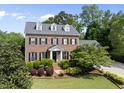 Beautifully landscaped brick home featuring black shutters and a welcoming front entrance at 101 Conway Ct, Cary, NC 27513
