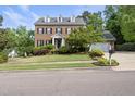Traditional brick home with a well-manicured lawn, two-car garage, and inviting curb appeal at 101 Conway Ct, Cary, NC 27513