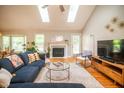 Bright living room featuring skylights, hardwood floors, fireplace, and contemporary furnishings at 101 Lakeshore Dr. Dr, Durham, NC 27713