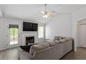 Bright living room with vaulted ceilings, fireplace, and gray sectional sofa at 1021 S Fieldhaven Dr, Fuquay Varina, NC 27526