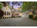 Stunning home with well-maintained landscaping, a circular driveway, and a spacious three-car garage at 108 Martinique Pl, Cary, NC 27511