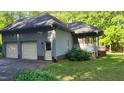 View of the home's attached garage and screened in porch at 113 Colonial Dr, Wendell, NC 27591