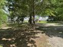 Exterior of the home, showcasing ample parking, and a peaceful, shaded setting at 113 Pineview Dr, Louisburg, NC 27549