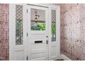 Elegant front door featuring leaded glass sidelights and transom with marble patterned wallpaper at 130 N Bloodworth St, Raleigh, NC 27601
