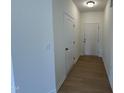 Bright entryway with wood-look floors, white walls, and a front door at 152 Bruce Dr, Dunn, NC 28334