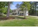 Beautiful home featuring a lush lawn, mature trees, updated exterior, and attached garage in quiet neighborhood at 1532 Cone Ave, Apex, NC 27502