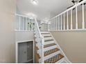 A staircase with carpeted steps and white railings leads to the upper level, showcasing the home's interior design at 1532 Cone Ave, Apex, NC 27502