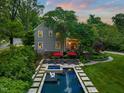 Aerial view of a backyard featuring a luxurious pool, spa, and lounge area for relaxing at 1603 Hermitage Ct, Durham, NC 27707