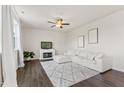 Cozy living room featuring a fireplace, plush sectional sofa, and neutral decor at 176 Belleforte Park Cir, Garner, NC 27529