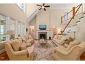 Bright living room boasting soaring ceilings, a fireplace, and a staircase to the second floor at 19002 Stone Brk, Chapel Hill, NC 27517