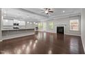Spacious living room with hardwood floors, a cozy fireplace, and natural light from large windows at 2005 Delphi Way, Wake Forest, NC 27587