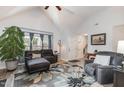 Bright living room with vaulted ceilings, modern furniture, and an accent rug at 205 Braxcarr St, Holly Springs, NC 27540
