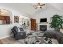 Open concept living room featuring vaulted ceilings, fireplace, and views to the breakfast nook at 205 Braxcarr St, Holly Springs, NC 27540
