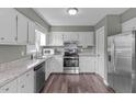 Well-lit kitchen featuring modern appliances, stainless steel refrigerator and plenty of cabinet storage at 205 Twin Oaks Dr, Angier, NC 27501